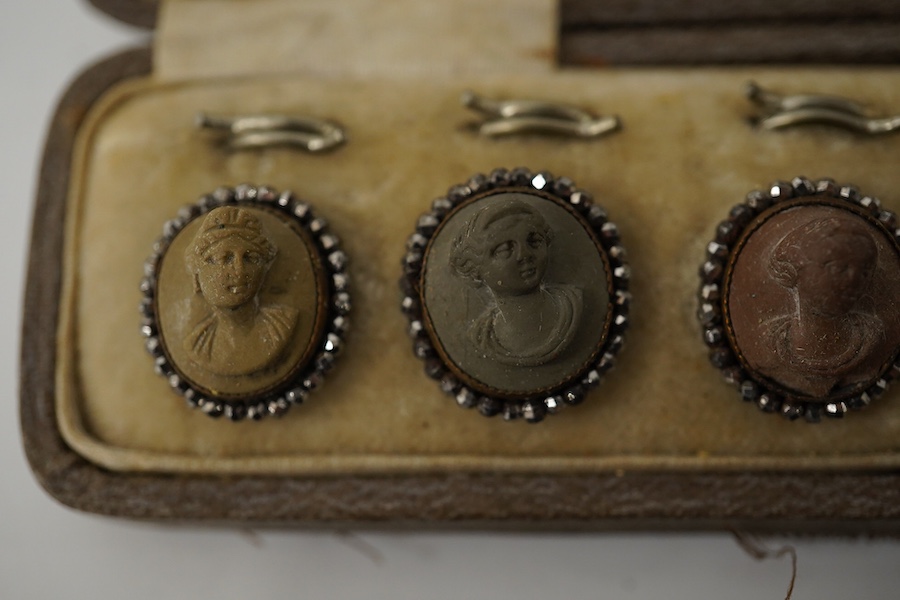 A cased set of 6 late Victorian carved lava buttons with cut steel borders, each carved with a classical female bust, 16mm and a cased set of 6 mother of pearl dress studs with gilt backs., Condition - cut steel border t